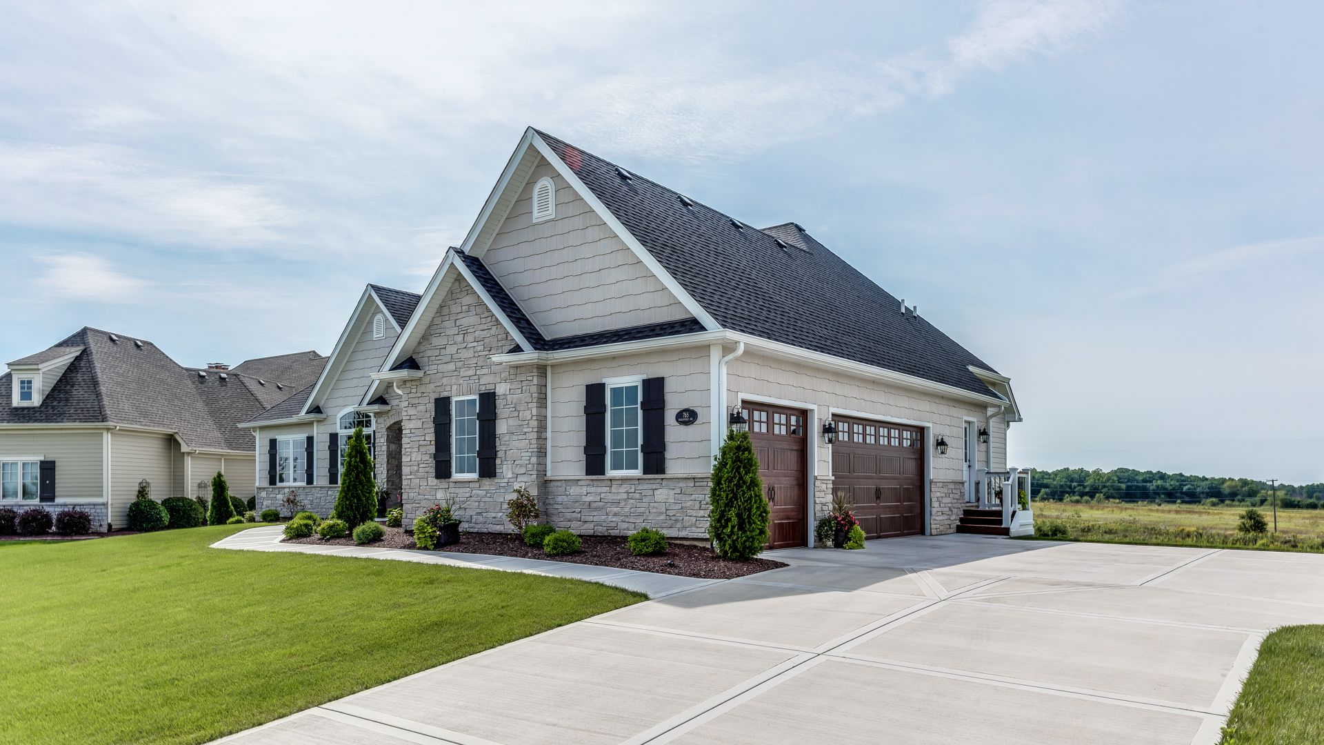 122401050949550 A dwelling with a driveway leading to a grassy area, illustrating a pleasant suburban setting.